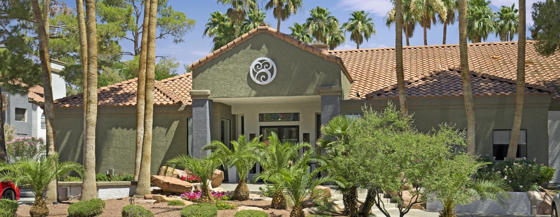 a building with palm trees and bushes
