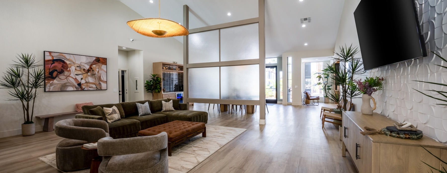 a resident lounge with a wood floor and a table and chairs
