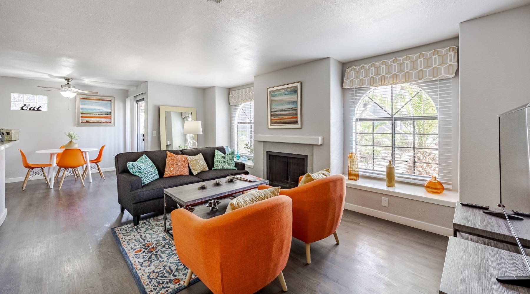 a living room with orange chairs