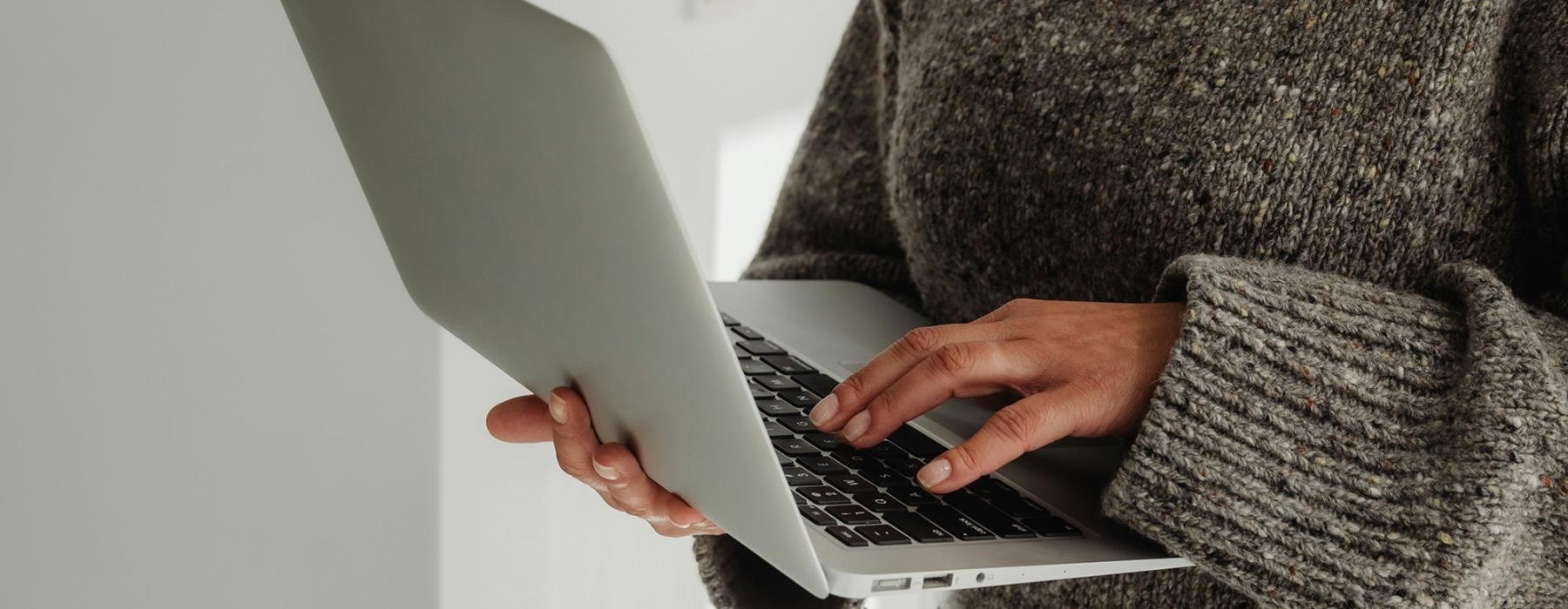 A person holding a laptop.