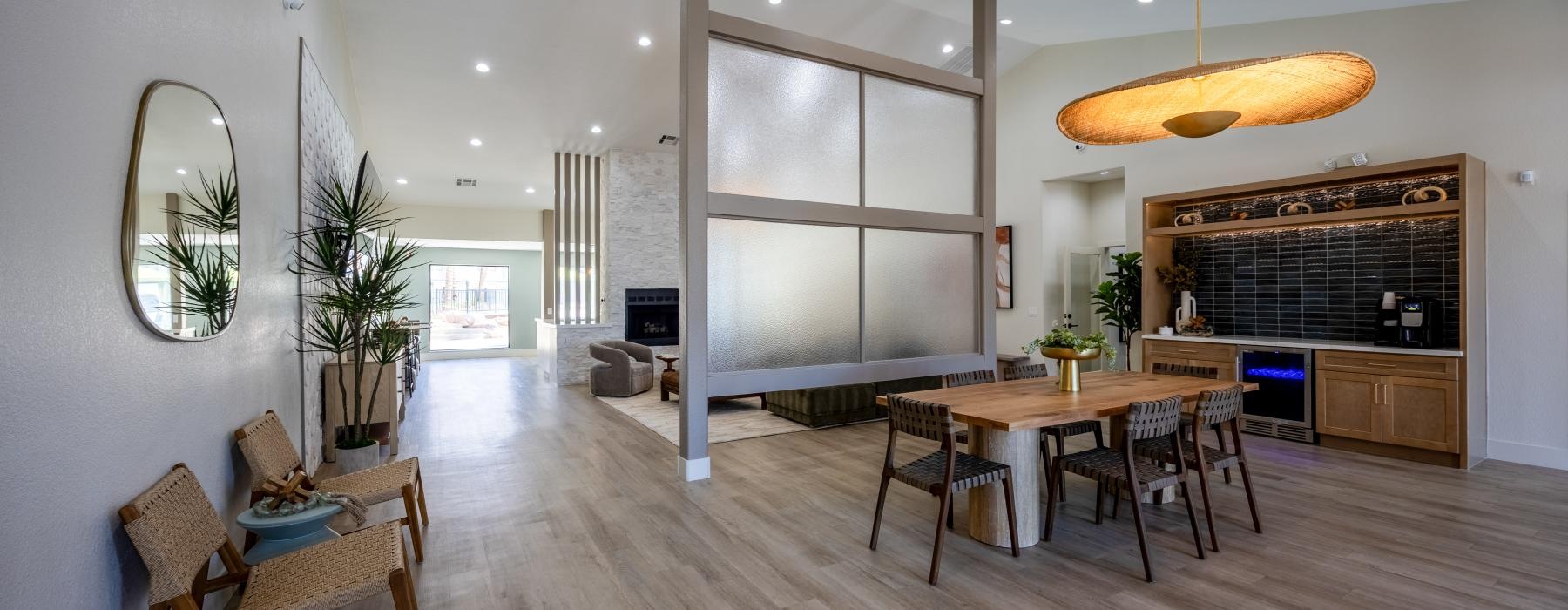 a large living room with a wood floor and a dining table